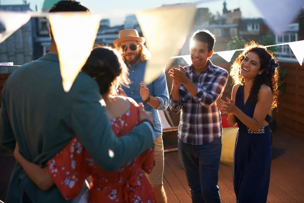 Friends congratulate couple who have just become engaged