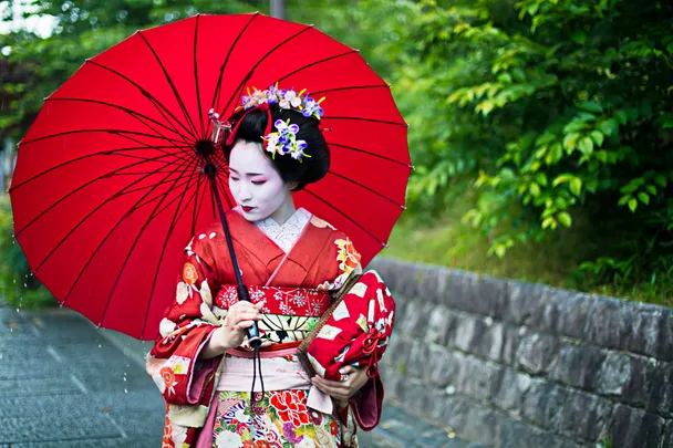 A geisha with a red umbrella