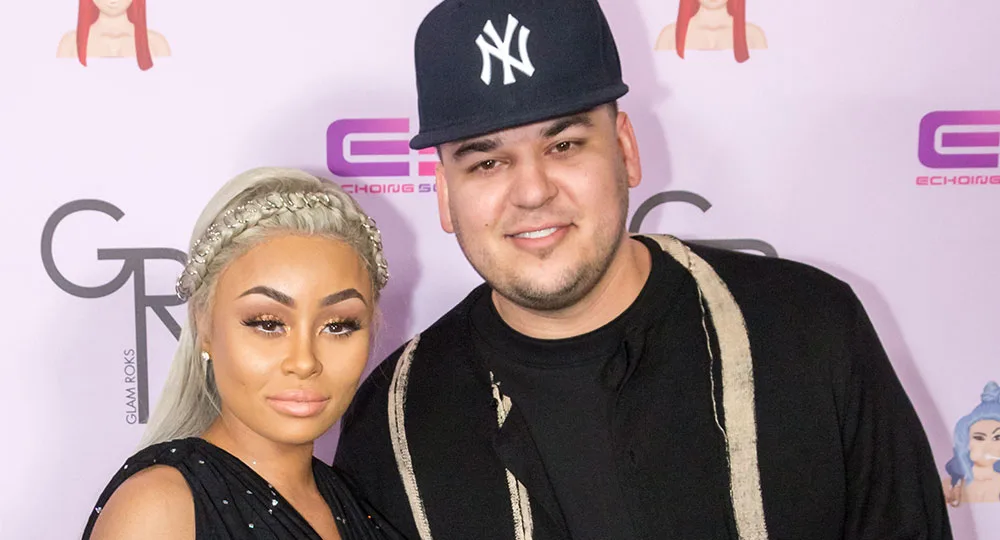 I don't know who these people are, but they are posing together in front of a backdrop with various logos.