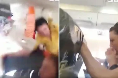 The horrifying moment a flight attendant crashes into the roof of a plane