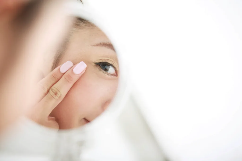 Lady putting cream under eye