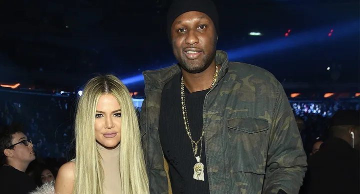 Khloe Kardashian and Lamar Odom at an event, standing together with a crowd in the background.