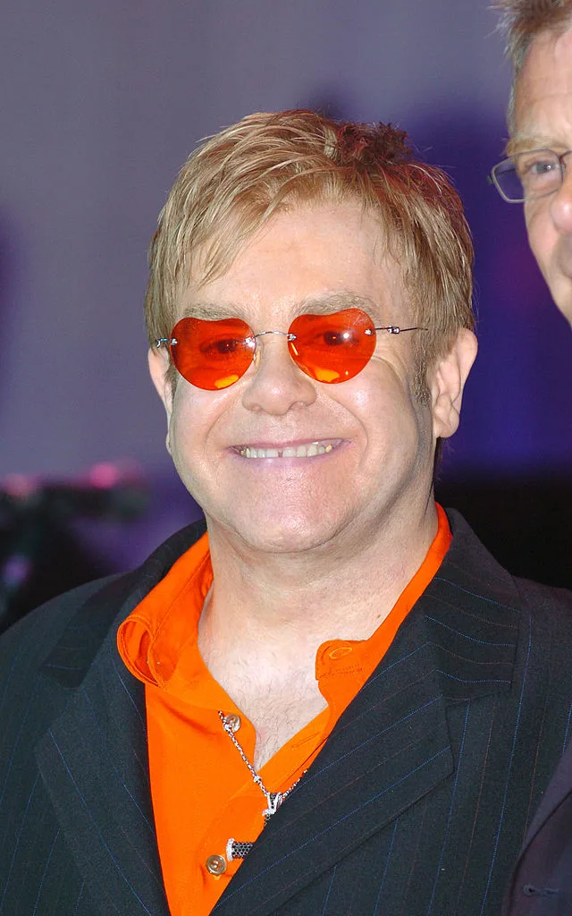 Elton john wearing a pair of red glasses