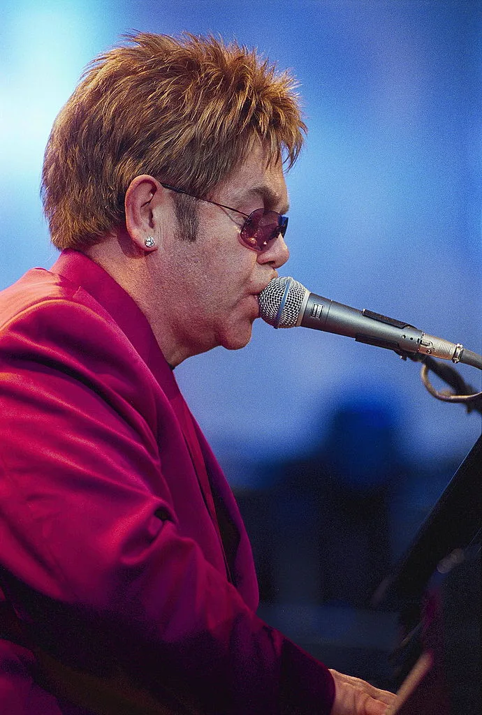 Elton John performing at a concert live in Elton John