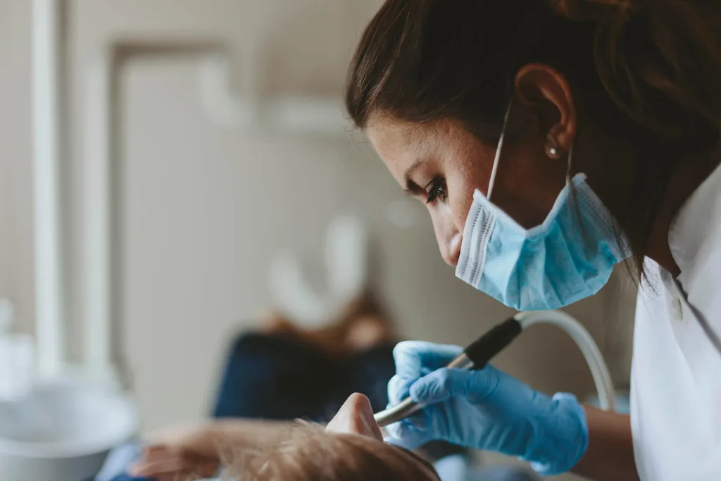 A dentist cleaning a patient's teeth