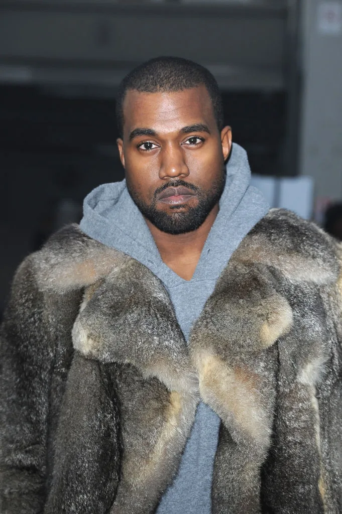 Kanye West wearing a furt coat