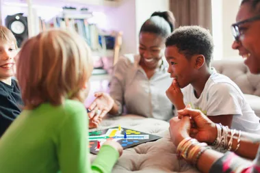 Family & Friends playing a game of Ludo board game
