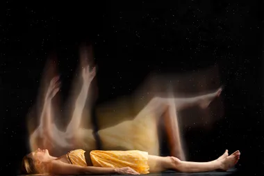 A woman in a yellow dress leaving her physical body in a spirit body