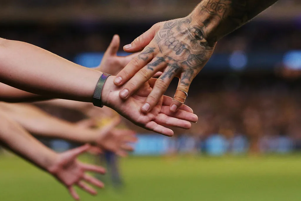 Dustin Martin's hand brushing against fans
