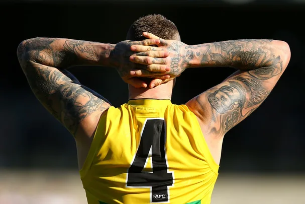 Dustin Martin's showing off his arm tattoos in the afternoon sun
