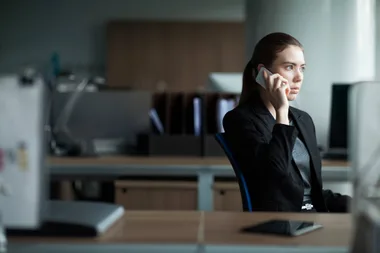 A woman in a suit on a business call