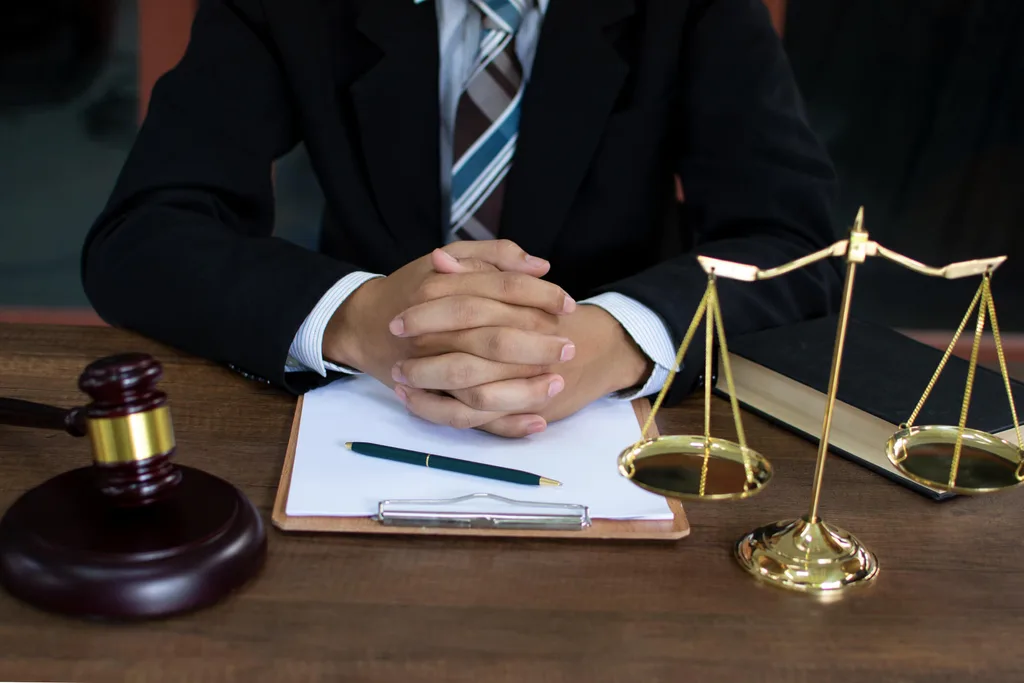 A man in a suit with a brass scale and file