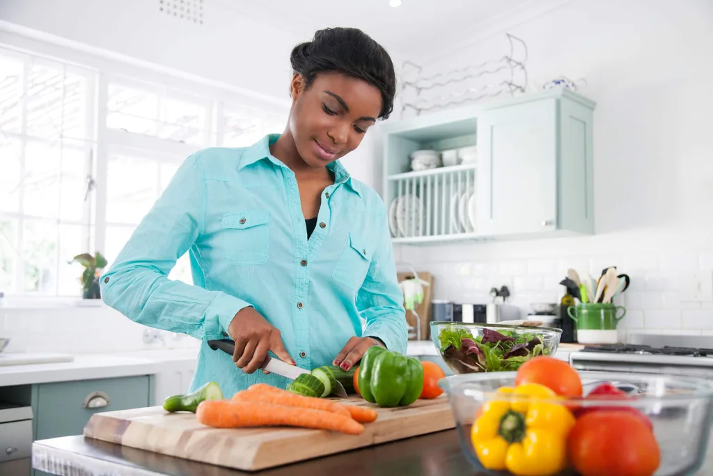 Woman chopping up vegetables in the kitchen