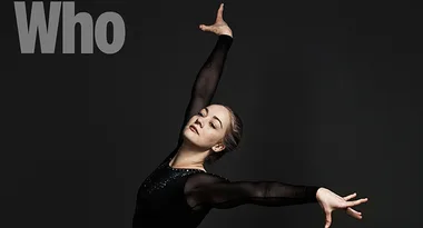 Dancer posing gracefully against a dark background with "Who" text above.
