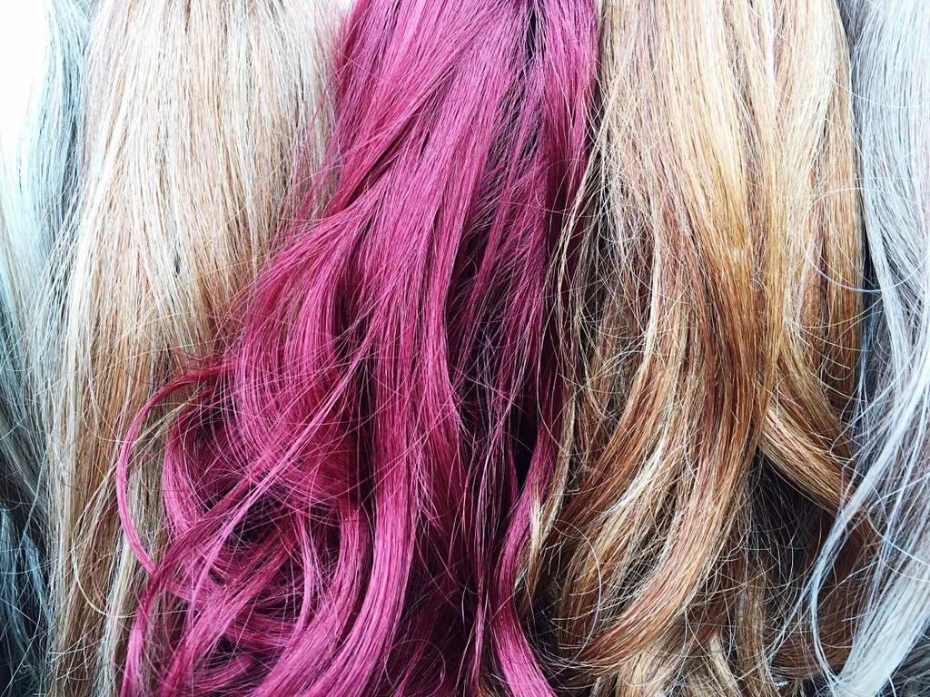 A woman's hair with a pink dyed streak