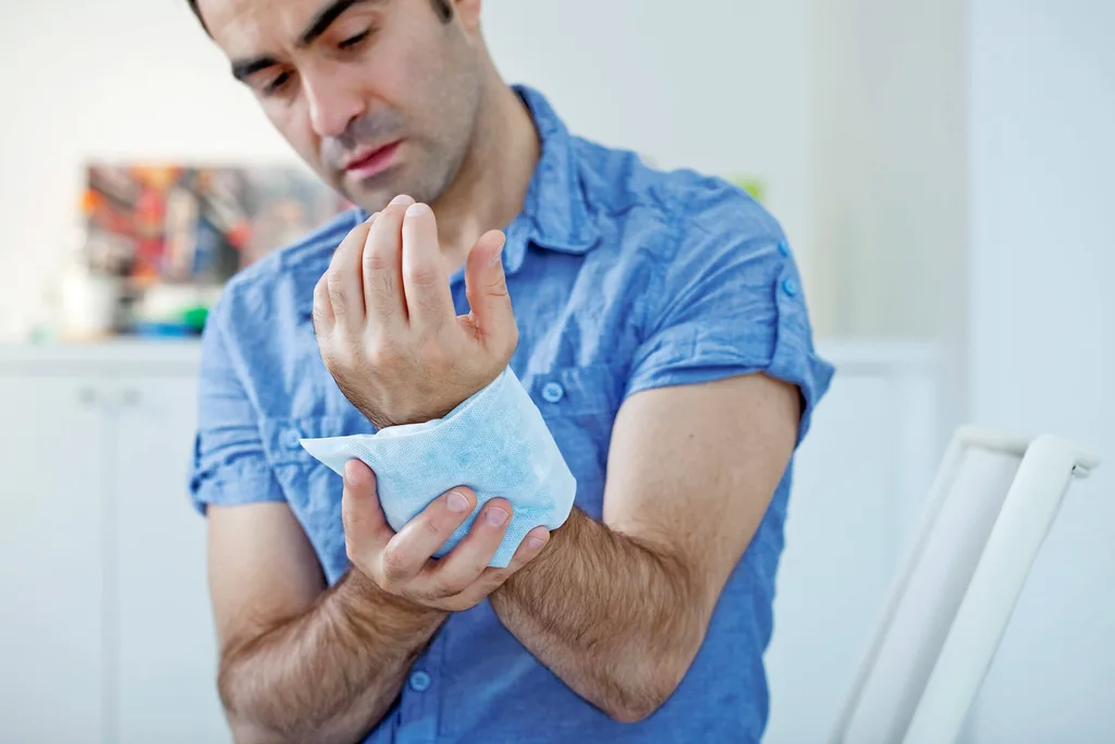Man holding an ice pack against his wrist