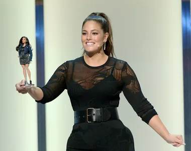 Ashley Graham holding a custom Ashley Graham Barbie