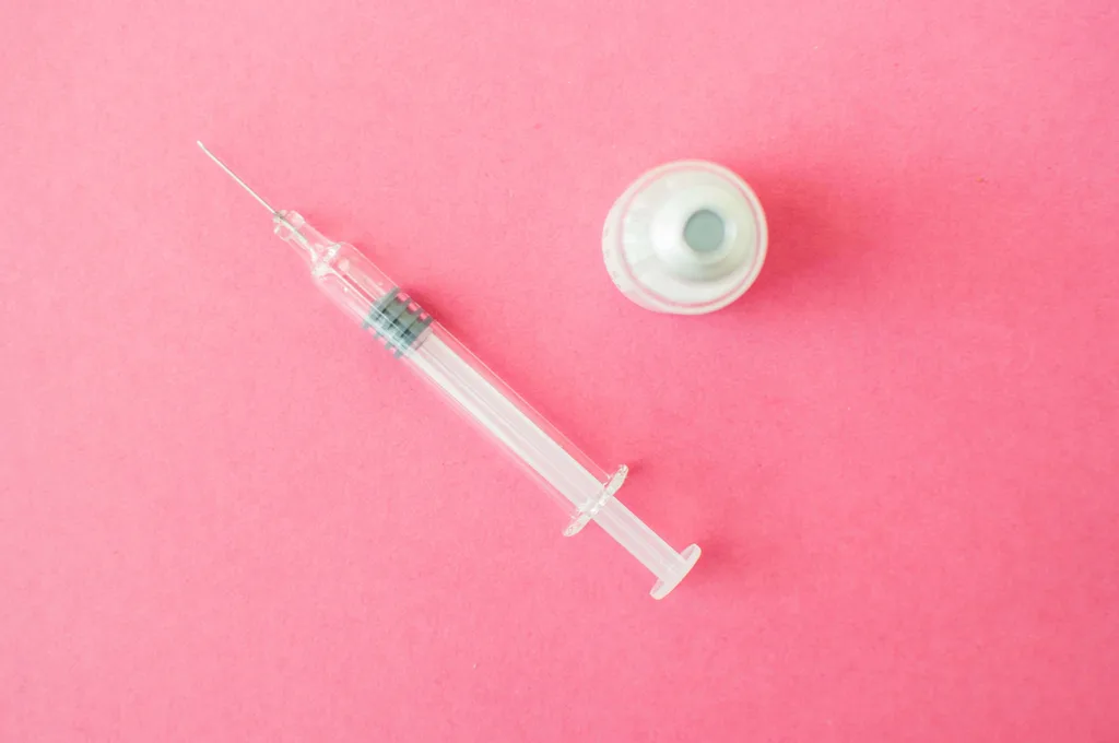 Needle lying on a pink table
