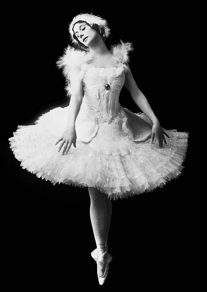 A picture of Anna Pavlova in a ballet outfit against a black background