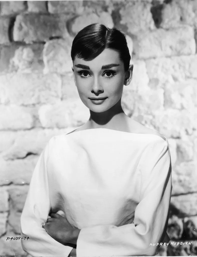 A black and white portrait of Audrey Hepburn