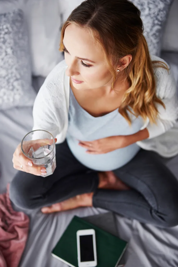 A pregnant woman drinking water