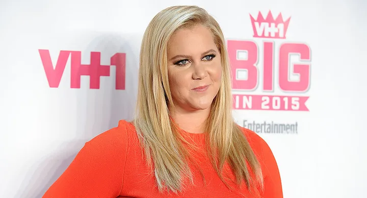 A woman in a red dress poses at the VH1 Big In 2015 event.