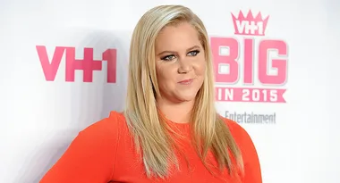 A woman in a red dress poses at the VH1 Big In 2015 event.