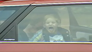 Cheeky little Prince Harry sticks tongue out at press
