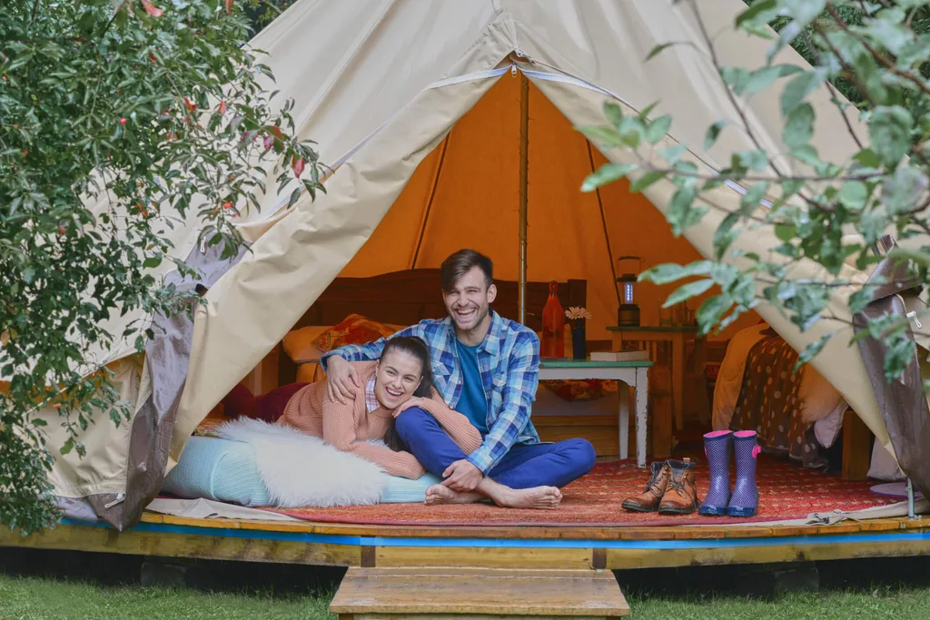 A couple luxury camping between trees