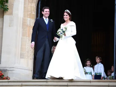 Princess Eugenie alongside Jack Brooksbank standing on the top of a set of stairs