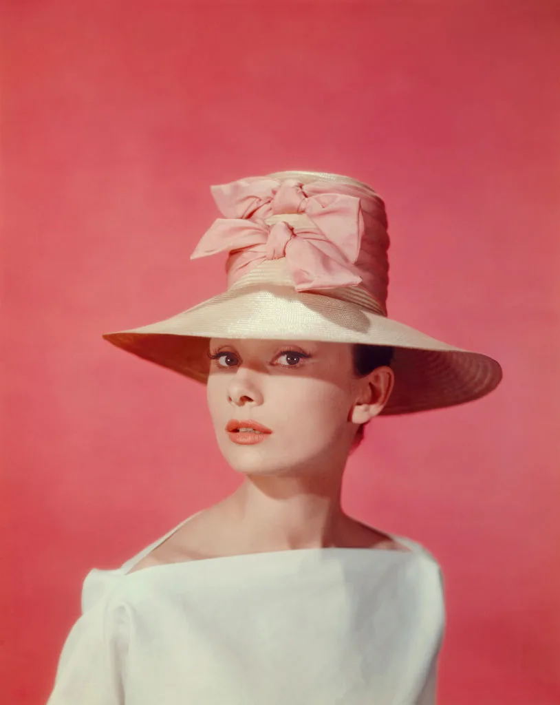 Audrey Hepburn wearing a wide-brim hat and white shirt, pictured during the filming of 'Funny Face'
