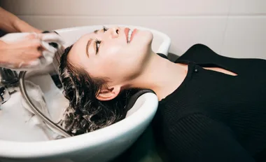 A woman getting her hair washed at a hairdresser