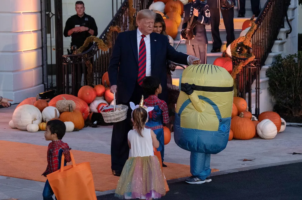 Donald Trump unsure how to give a child dressed as minion Halloween lollies