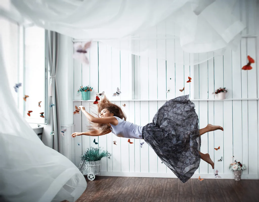 A woman floating in a room surrounded by butterflies