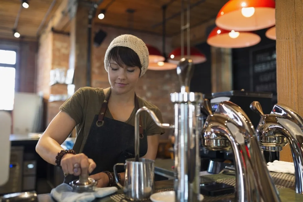 A barista making coffee in a cafe