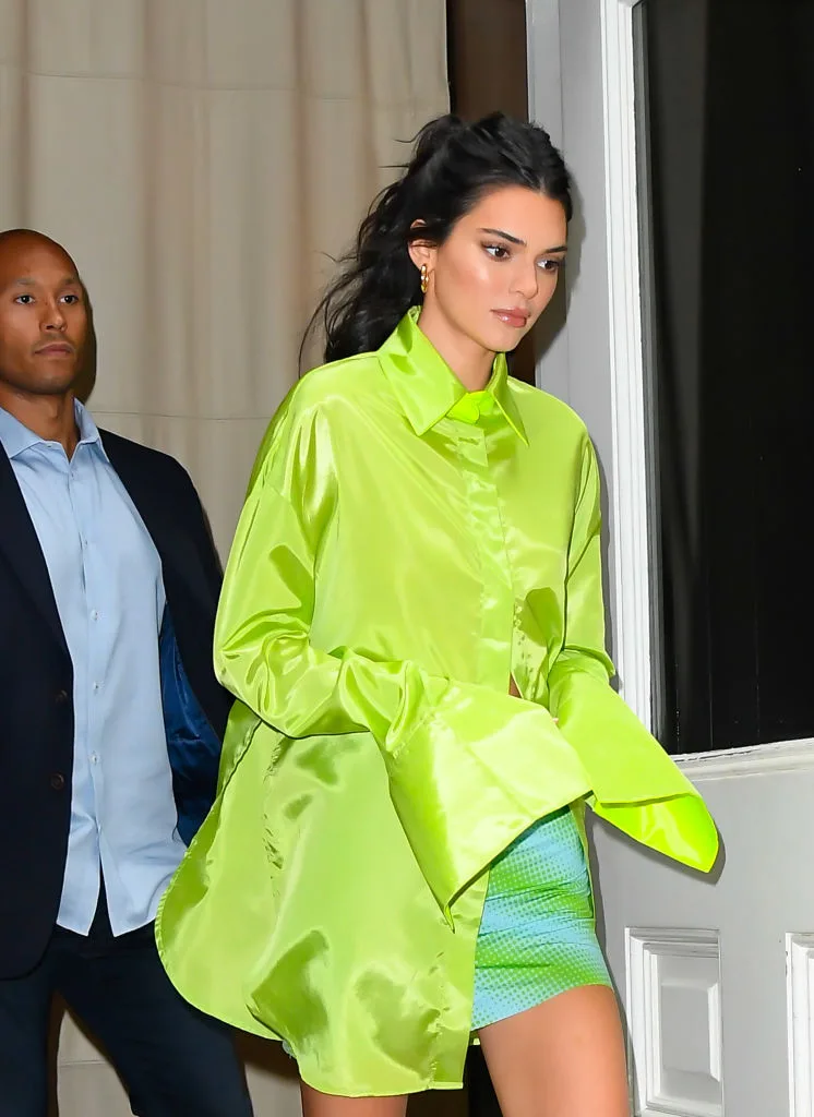 Kendall Jenner in a green jacket and a green skirt