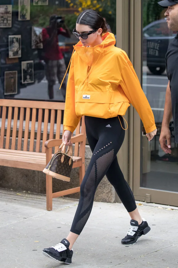 Kendall Jenner wearing a yellow hoodie with gym pants
