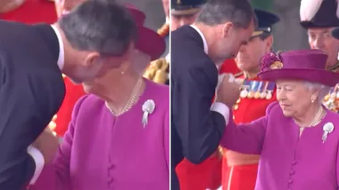 The King of Spain greets the Queen with a kiss