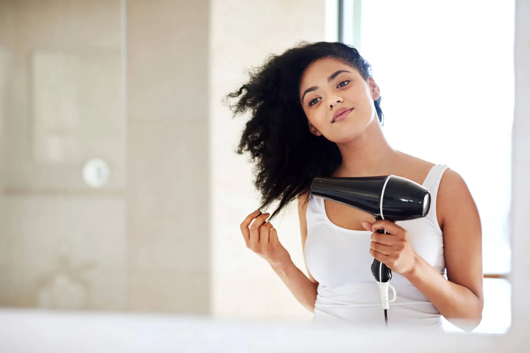 Woman blowing her hair with a hairdryer