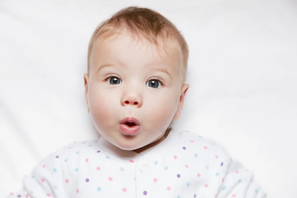 A baby pulling a face at the camera