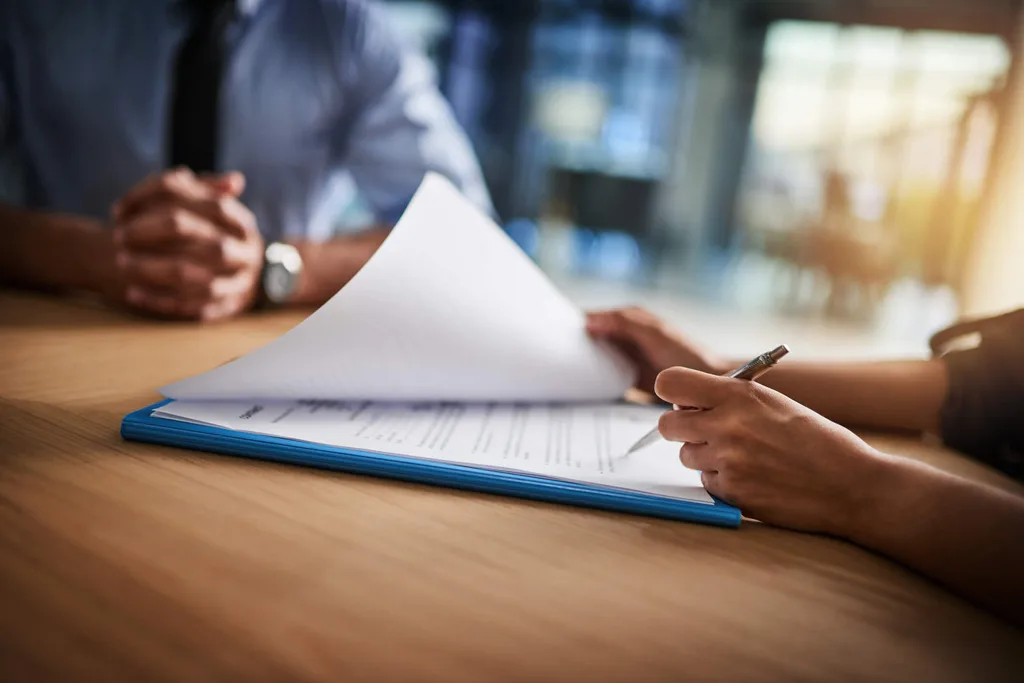 A person reading through the fine print of a contract