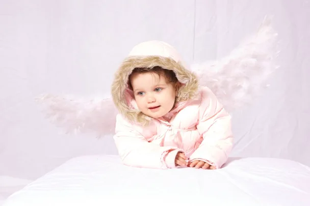 A baby with a puffy pink jacket with wings