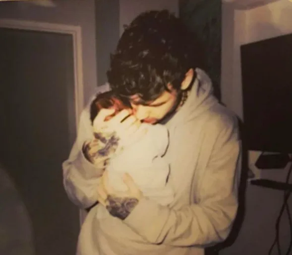 Liam Payne holds his infant son bear