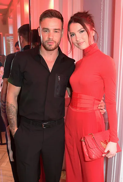 Liam Payne wears black and Maya Henry wears red