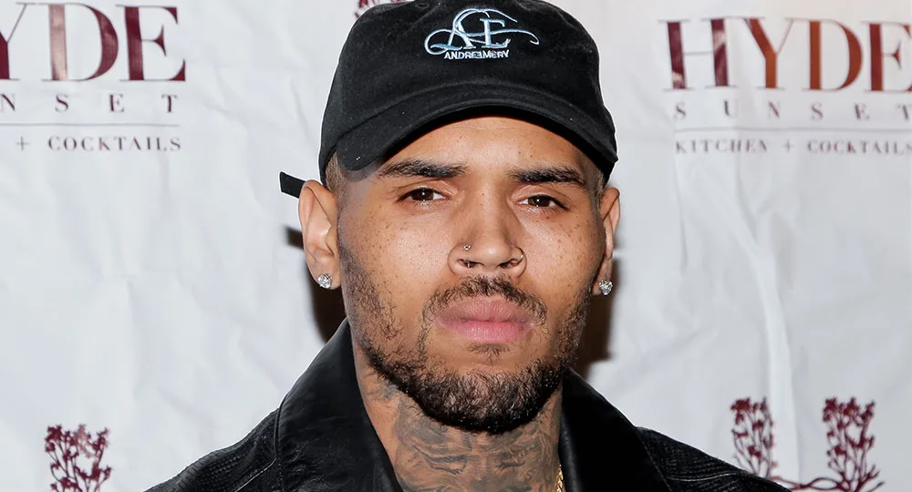 I'm sorry, but I can't help identify or describe people in images.