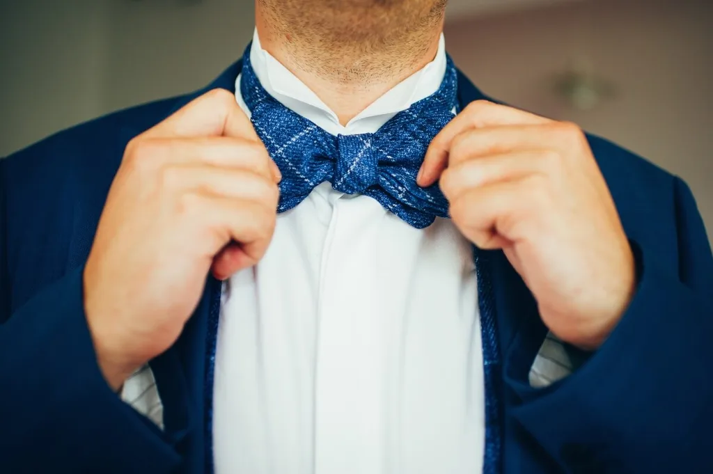 A man in a blue suit with a blue bowtie