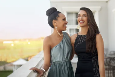 Two formally dressed girls on a balcony
