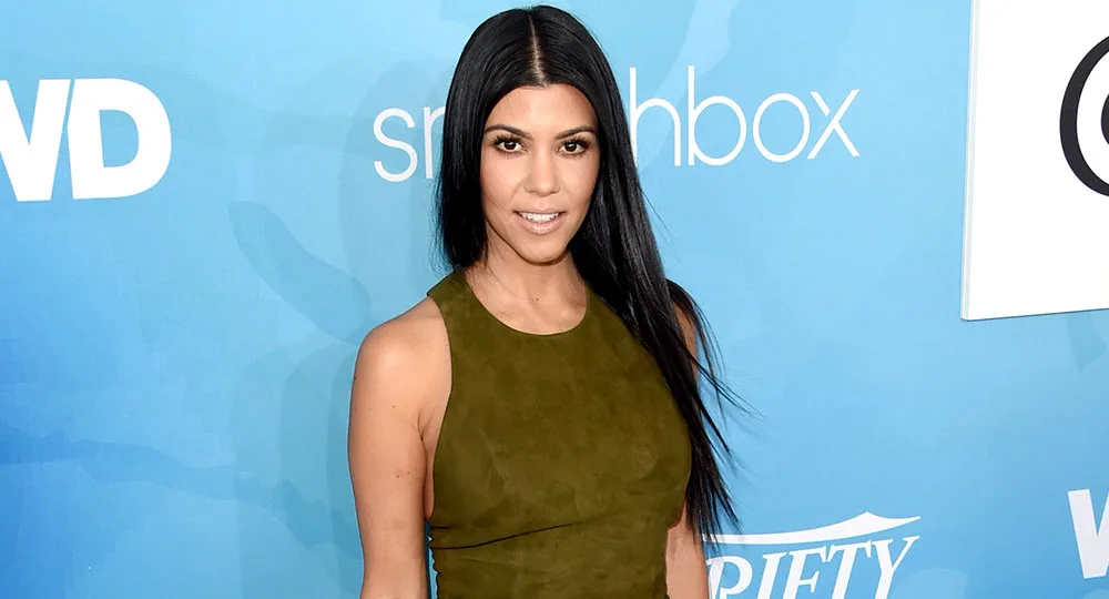 Kourtney Kardashian flaunts her fit figure in cut-out swimsuit
