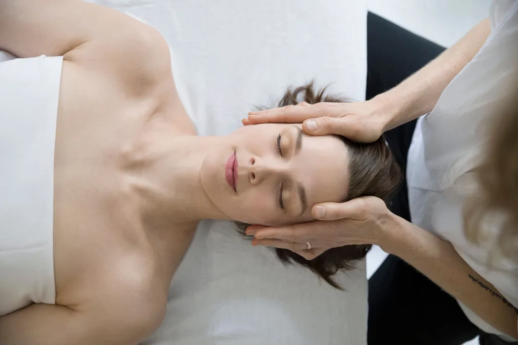 A woman massaging a woman's head