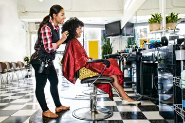 A hairdresser showing her customer the final hairstyle